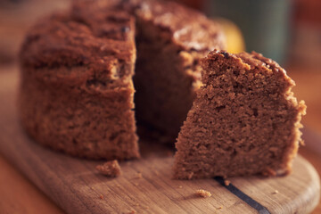 A close-up of a pie where a piece is cut off from the whole part. Diet dessert - Banana cake without milk, gluten-free, egg-free. High quality photo