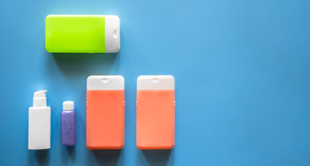 Flat lay spa composition with skin care products on blue background.