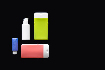 Flat lay spa composition with skin care products on black background.