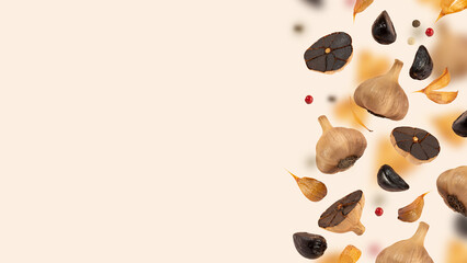 Black garlic bulbs levitate in the air on a beige background. An image of a floating black garlic. The concept of fermented and vegetarian food. Healthy nutrition, self care. Copy space. Horizontal
