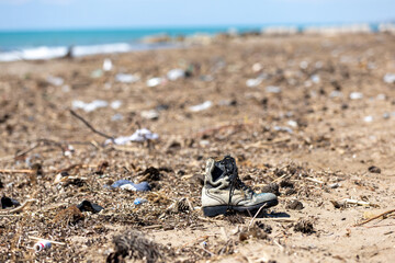 Environmental pollution, beached garbage and old shoes