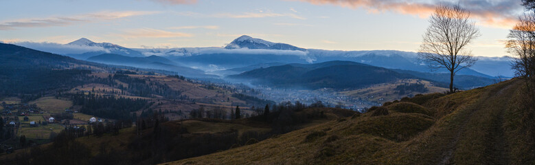 Picturesque pre sunrise morning above late autumn mountain countryside. Ukraine, Carpathian Mountains, Hoverla and Petros tops in far.