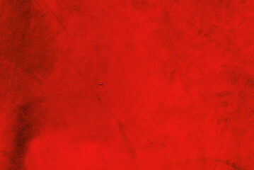 Red matte background of suede. Velvet texture of seamless leather. Red suede texture.