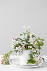 Beautiful composition with early spring flowers in a white cup. Wedding decor, bride morning. Copy space for text