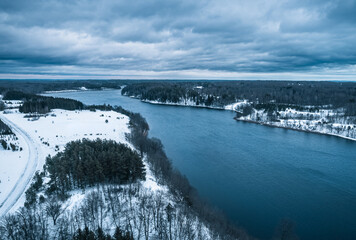Tauragnai town and lake aerial perspective landscape with snow from drone	