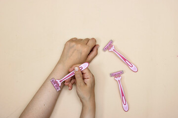Hands are shaved, armpits or plucking the armpits by using a razor, Depilation and skin care concept