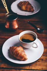 Cup of Turkish Coffee And Croissant on White Plate for Breakfast