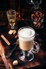 Coffee with Irish whiskey and whipped cream in glass
