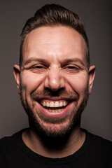 Portrait of young man smiling in studio