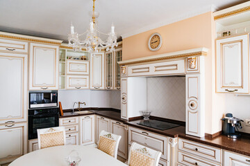 The interior of a large and spacious kitchen-living room in a classic style. 