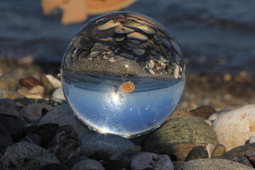 waves crashing on glass ball and sea view