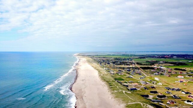aerial view along the endless beaches on the coast of denmark and jutland, vrist with block towards thyboron and the limfjord in summer, Lemvig, Denmark 