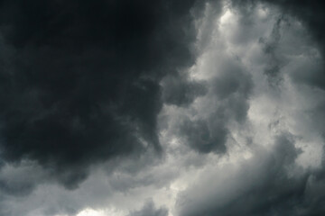Fototapeta premium Dark, gloomy, stormy, rainy sky with rays of light. Terrible hurricane clouds. Background image for design