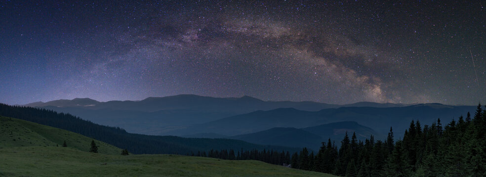 starry night sky panorama with milky way and mountains