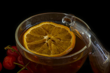 Transparent cup of tea with orange