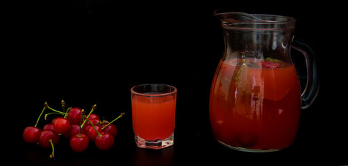 Compote with cherries and mint on a black background