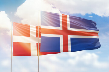 Sunny blue sky and flags of iceland and denmark