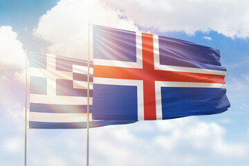 Sunny blue sky and flags of iceland and greece