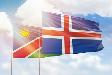 Sunny blue sky and flags of iceland and namibia