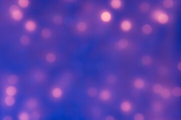 Purple sparkle bokeh background with flowing lights