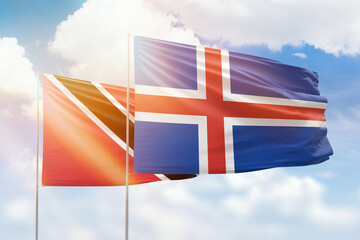 Sunny blue sky and flags of iceland and trinidad and tobago