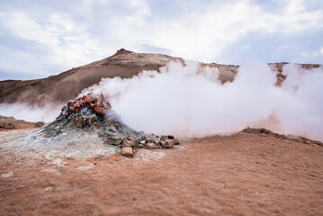 Steam emitting from fumarole in geothermal area of Hverir. Sulphur dioxide erupting from volcanic...