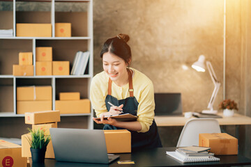 Partnership of SME entrepreneur teamwork of small business work at home family online marketing with packing box prepare for deliverty to customers at warehouse home seller office