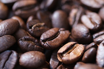 Coffee roasted beans closeup, coffee macro close up, selective focus. Defocused natural blurred background.
