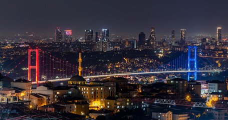 Fototapeta na wymiar Istanbul Bosphorus Bridge 15th July Martyrs Bridge. Night view from Camlica Hill. Istanbul, Turkey.