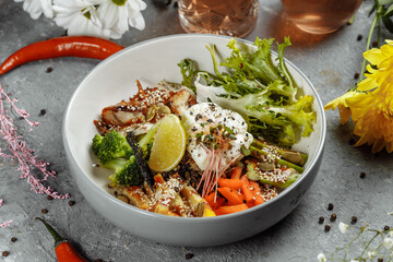 Healthy bowl - quinoa salad with tuna, broccoli, avocado on wooden rustic table. top view