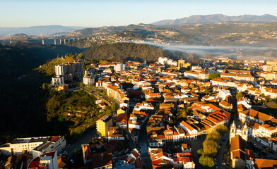 Picturesque drone view of Vila Real cityscape in valley framed by Alvao and Marao mountain ranges...