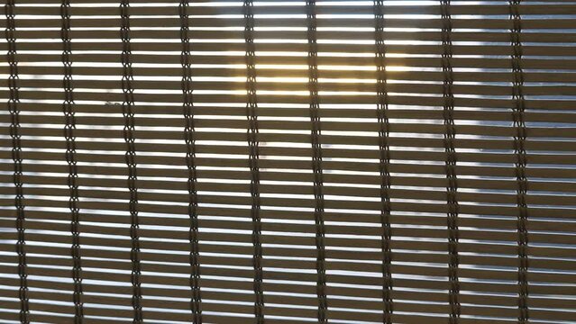 Wooden and bamboo blinds on home windows. Closeup