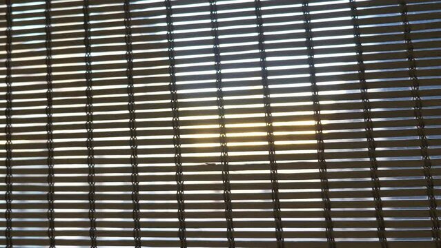 Wooden and bamboo blinds on home windows. Closeup