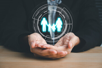 Person hand holding paper family cutout, family home, adoption, foster care, homeless support, family mental health, autism support, domestic violence, social distancing.