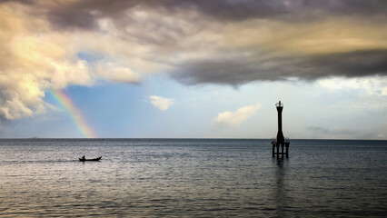 Rainbow over the sea with little boat