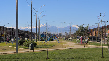 Urban park in a small town of Chile, Andes mountains in background