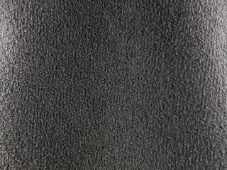 Close-up of black glossy fabric sunglasses. Background and textured.