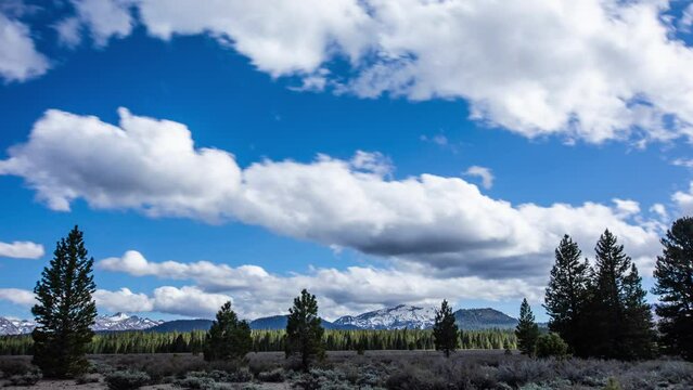 Time Lapse - Beautiful cloudscape moving over snowcapped mountain ranges