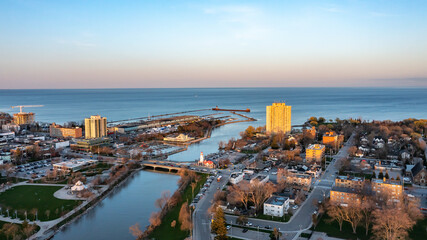 Fototapeta na wymiar Aerial view of Port Credit at the mouth of the Credit River at sunset facing Lake Ontario in the summer.