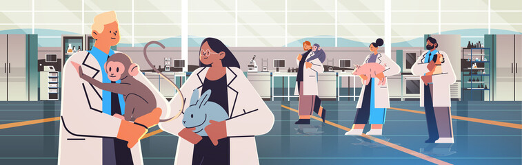 scientists or veterinary workers doing experiments in lab with experimental animals biological genetic engineering research