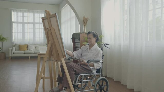 Artist concept of 4k Resolution. Asian woman drawing in the living room. Artist is creating work. People with disabilities are creating hobbies.