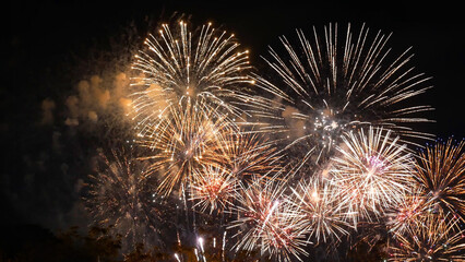 Golden Firework celebrate anniversary happy new year 2023, 4th of july holiday festival. Gold firework in the night time celebrate national holiday. Countdown to new year 2022 gold party time event