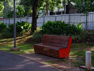 modern park bench made of wooden planks at the public park