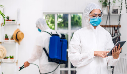 Professional teams for disinfection worker in protective mask and white suit disinfectant spray cleaning virus for help service kill coronavirus at customer home