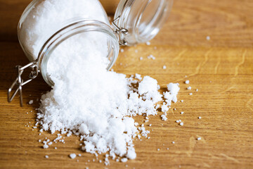 salt on wooden background.