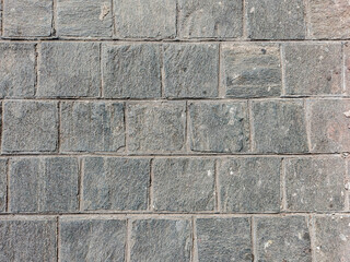 Granite cobblestoned pavement background. Stone pavement texture. Abstract background of cobblestone pavement close-up