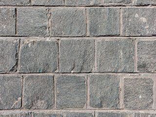 Granite cobblestoned pavement background. Stone pavement texture. Abstract background of cobblestone pavement close-up