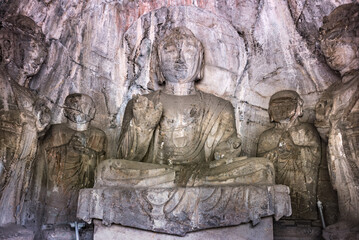 Fototapeta na wymiar Longmen Grottoes or Longmen Cave with Buddha's figures are Starting with the Northern Wei Dynasty in 493 AD. It is one of the four notable grottoes in China, located in Luoyang City, Henan Province.