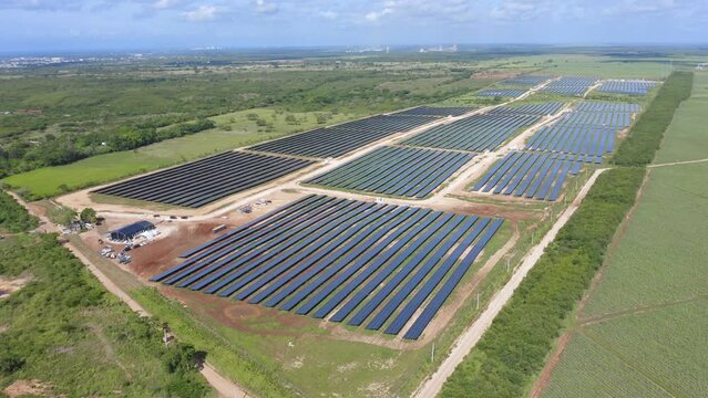 Aerial drone ascending pov over El Soco solar photovoltaic park of San Pedro De Macoris in Dominican Republic