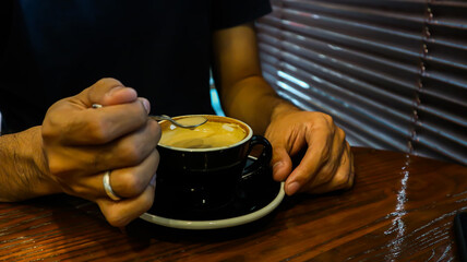 Fototapeta na wymiar a glass of hot cappuccino in a cafe